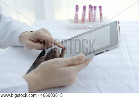 Doctor Hands Use A Tablet, Hospital Lab, On The Work Table,working Doctor,white Office Of The Hospit