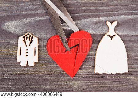 Broken Heart With Scissors. Divorse And Heartbreak Concept. Grey Wood Background.