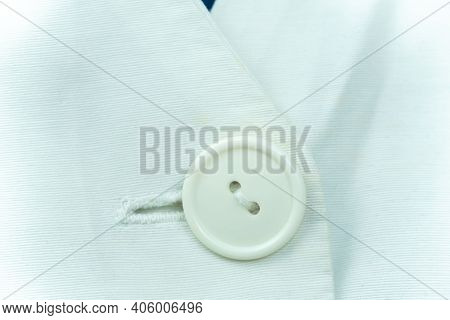 Close-up Of A White Button On A White Medical Cotton Robe, Macrophotograph