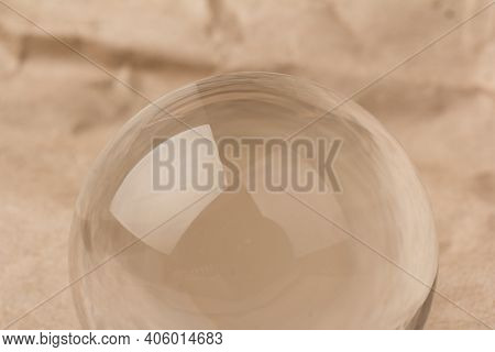 Crystal, Transparent Ball, Sphere On  Crumpled Paper Background.