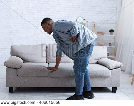 Black Guy Having Stomachache Touching Stomach Suffering From Painful Abdominal Spasm Standing Near S