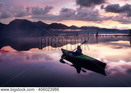 Adventurous Girl Kayaking On An Infatable Kayak In A Beautiful Lake. Colorful Peaceful Sunrise Art R