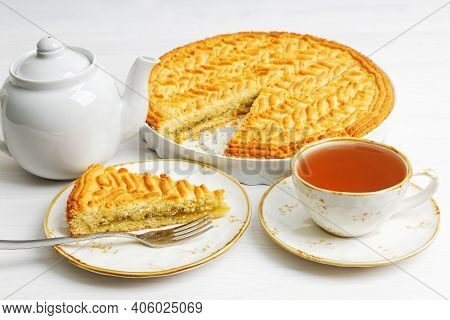 Homemade Gooseberry Lemon Pie And Cup Of Tea On White Wooden Tabke.
