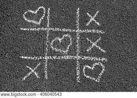 Chalk Tic Tac Toe Game With White Heart Drawings Instead Of Noughts, Black And White