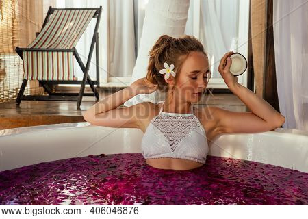 Woman Relaxing In Round Outdoor Bath With Tropical Flowers, Organic Skin Care, Luxury Spa Hotel Vale