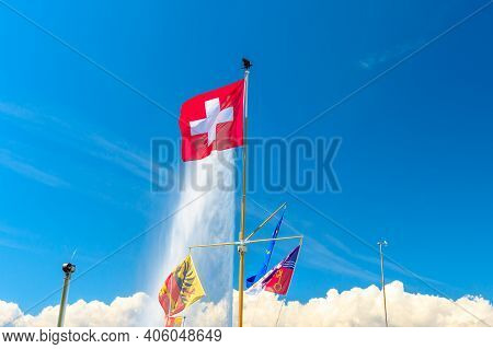 Swiss Flag, European Flag And Canton Of Geneva Flag And On Background The Most Famous Attraction And