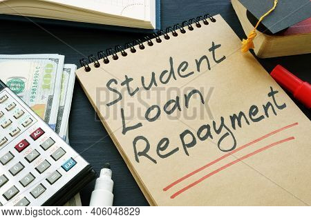Student Loan Repayment Sign, Notepads, Calculator And Cash.