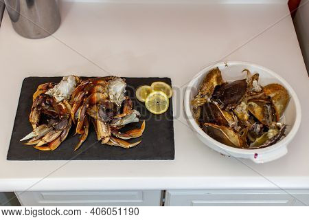 Dungeness Crab Legs Are Cleaned And Prepared To Be Cooked For Dinner. Crab Guts And Shells Are Disca