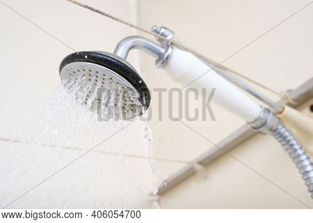 Water Flowing From An Old Shower Head With Ceramic Handle With Limescale Needed To Be Replaced Or De
