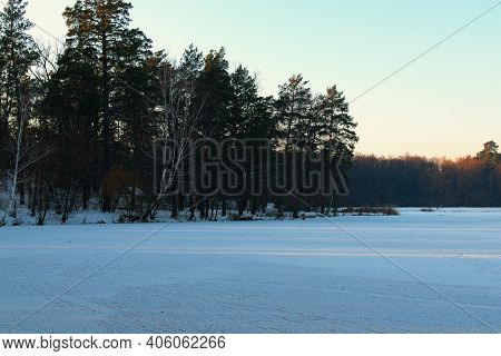 Amazing Winter Landscape Of Frozen Pond In The Forest. Evergreen Wood And Shore In Snow. Winter Seas