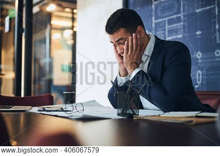 Confused Latin American Drafter Sitting At The Table