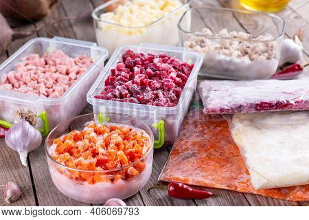 Frozen Food In Containers And Bags On The Table. Frozen Vegetables. Food Supplies For The Winter.