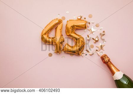 Happy 45th Anniversary Party. Champagne Bottle With Gold Number Balloon.