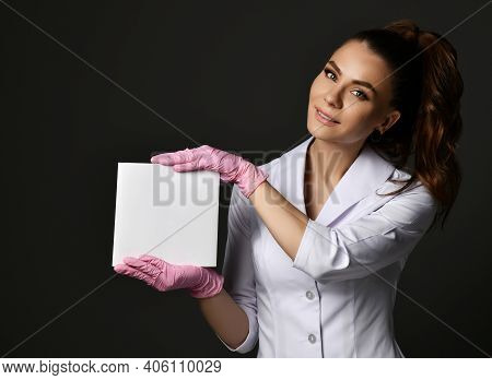 Young Smiling Brunette Woman Doctor Therapist Nurse In White Uniform And Protective Gloves Holding B