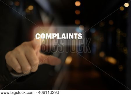 Complaints Concept. Businessman Pointing The Text Complaints Button On Virtual Screens.