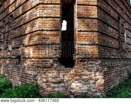 Ruined Red Brick Wall With Narrow Hole Close-up. Facade Of Tower Of The Former City Baths In Putyvl 