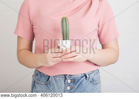 Girl Holding A Cactus On The Background Of The Stomach. Stitching Abdominal Pain Concept. Gastritis 