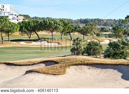 Picturesque Scenery Golf Course Green Field With Trees And Blue Lake During Warm Winter Sunny Day, M