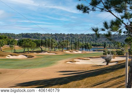 Picturesque Scenery Golf Course Green Field With Trees And Blue Lake During Warm Winter Sunny Day, M