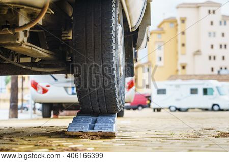 Caravan Leveling Block In Use. Leveler Ramp Chock Blocks For Rv Travel Trailer. Accessories For Moto