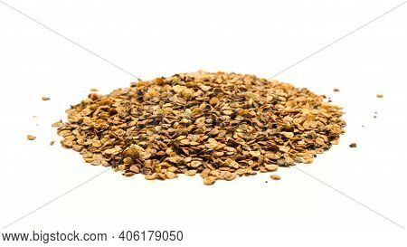 Large Mound Of Eggplant Or Aubergine Seeds In Plastic Container Isolated On White Background