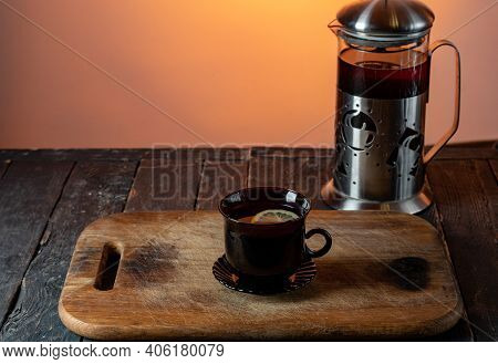 A Mug Of Tea On A Wooden Board. Tea With Lemon On Boards For Cutting. Tea With Lemon. View Of The Te