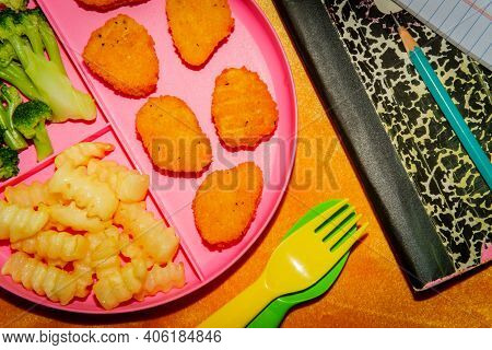 At Home Schooling Chicken Nugget Lunch Served On Tray With French Fries And Broccoli