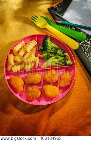 At Home Schooling Chicken Nugget Lunch Served On Tray With French Fries And Broccoli
