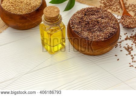 Flaxseeds In A Spoon And Bowl With A Bottle Of Flaxseed Oil And Flaxseed Flour