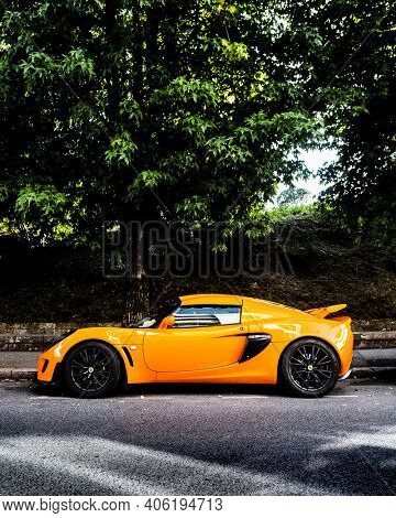 BAYONNE, FRANCE - CIRCA AUGUST 2020: An orange Lotus Exige S parked in the street.