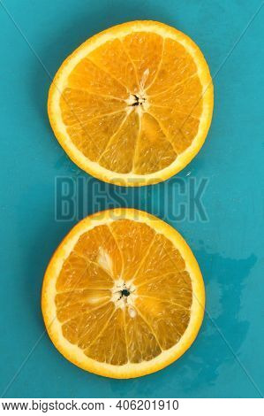 Close Up Of Two Round Orange Citrus Slices On Blue Background, Fresh Summer Mood. Stock Photo Blank 