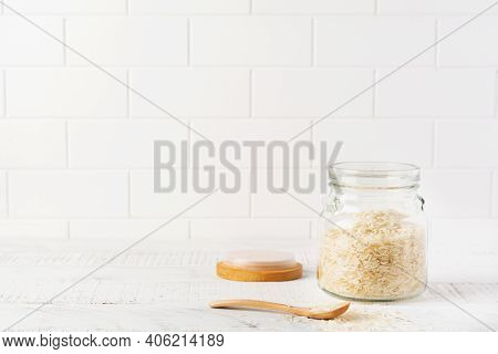 Raw White Rice Variety Arborio For Italian Risotto Dishes In Glass Jar On White Concrete Or Stone Ba