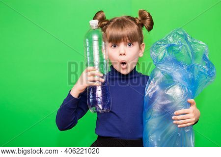 Girl Hold Trash Bag And Plastic Bottle And Shows Interest In Environmental Issues Isolated On Green 