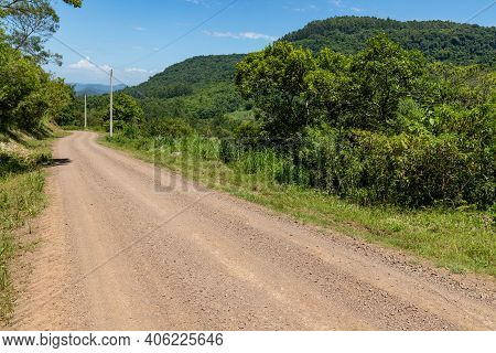 Dirty Road With Forest And Valley