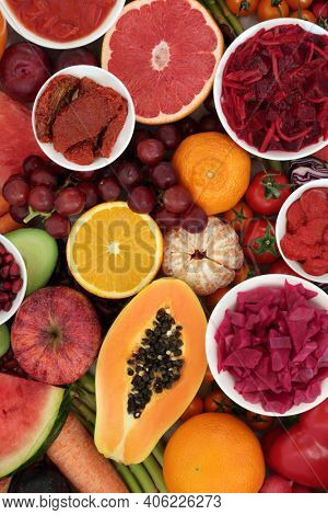 Vegan food high in lycopene for a healthy heart with plant based fruits and vegetables. Foods also high in antioxidants, dietary fibre, anthocyanins vitamins and minerals. Ethical eating. Top view.