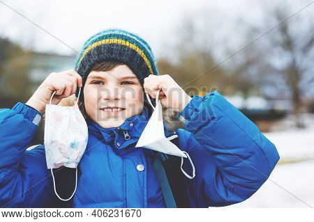 Kid Boy Wearing Ffp Medical Mask On The Way To School. Child Backpack Satchel. Schoolkid On Cold Aut