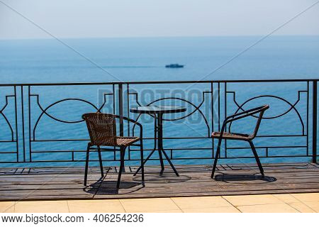 Chairs And Table On Protected Terassa By Sea