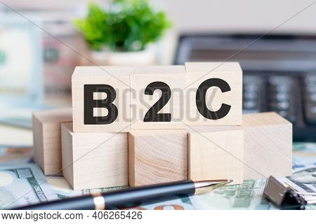 Dollars Banknote With Calculator And Word B2c. Banknotes And Wooden Cubes With Letters. Concept With