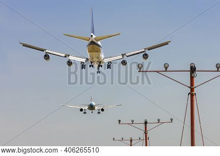 Rear View Of Two Airplanes For Commercial Passenger Or Cargo Transportation To Fly In Sequence And S