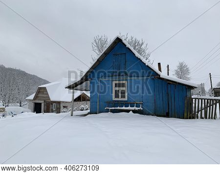 Wooden House In The Village In Winter. An Old Wooden Building By The Forest. Village House In The Mo