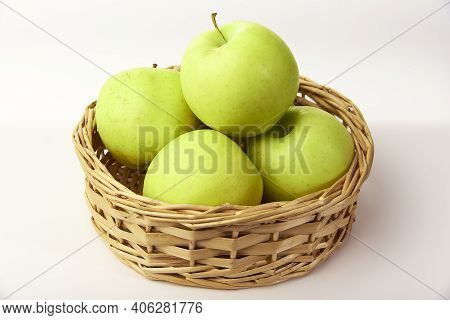 Green Apples In A Basket On A White Background