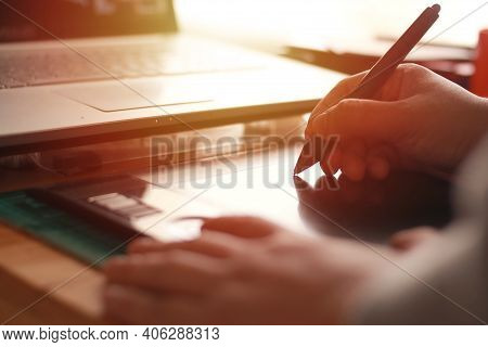 Anonymous Designer Working On Laptop Computer And Pentablet Graphic Tablet, Blurry Silhouette With S
