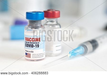 Medical Glass Vial And Plastic Syringe For Injection On White Table With Blue Gradient Background. C