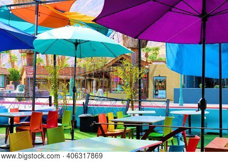 February 2, 2021 In Palm Springs, Ca:  Colorful Umbrellas Over Tables And Chairs On An Outdoor Patio