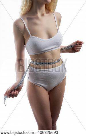 Close Up Photo Of Healthy Woman With Slim Belly Measuring Her Waists Size