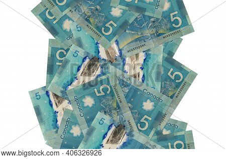 5 Canadian Dollars Bills Flying Down Isolated On White. Many Banknotes Falling With White Copy Space