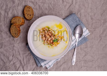 Vegetable Cream Soup With Beans And Spicy Oil In A Bowl On A Textile Background. Selective Focus.