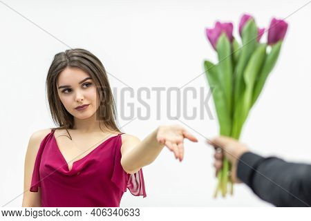 Beautiful Woman With Snobbish Expression, Looking With Skeptical Expression At The Bunch Of Tulips H