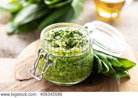Wild Leek Pesto With Olive Oil And Parmesan Cheese In A Glass Jar On A Wooden Table. Useful Properti