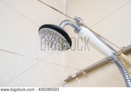 Water Flowing From An Old Shower Head With Ceramic Handle With Limescale Needed To Be Replaced Or De